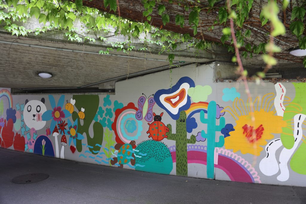 Kinder verwandeln graue Betonmauern in einen bunten Garten